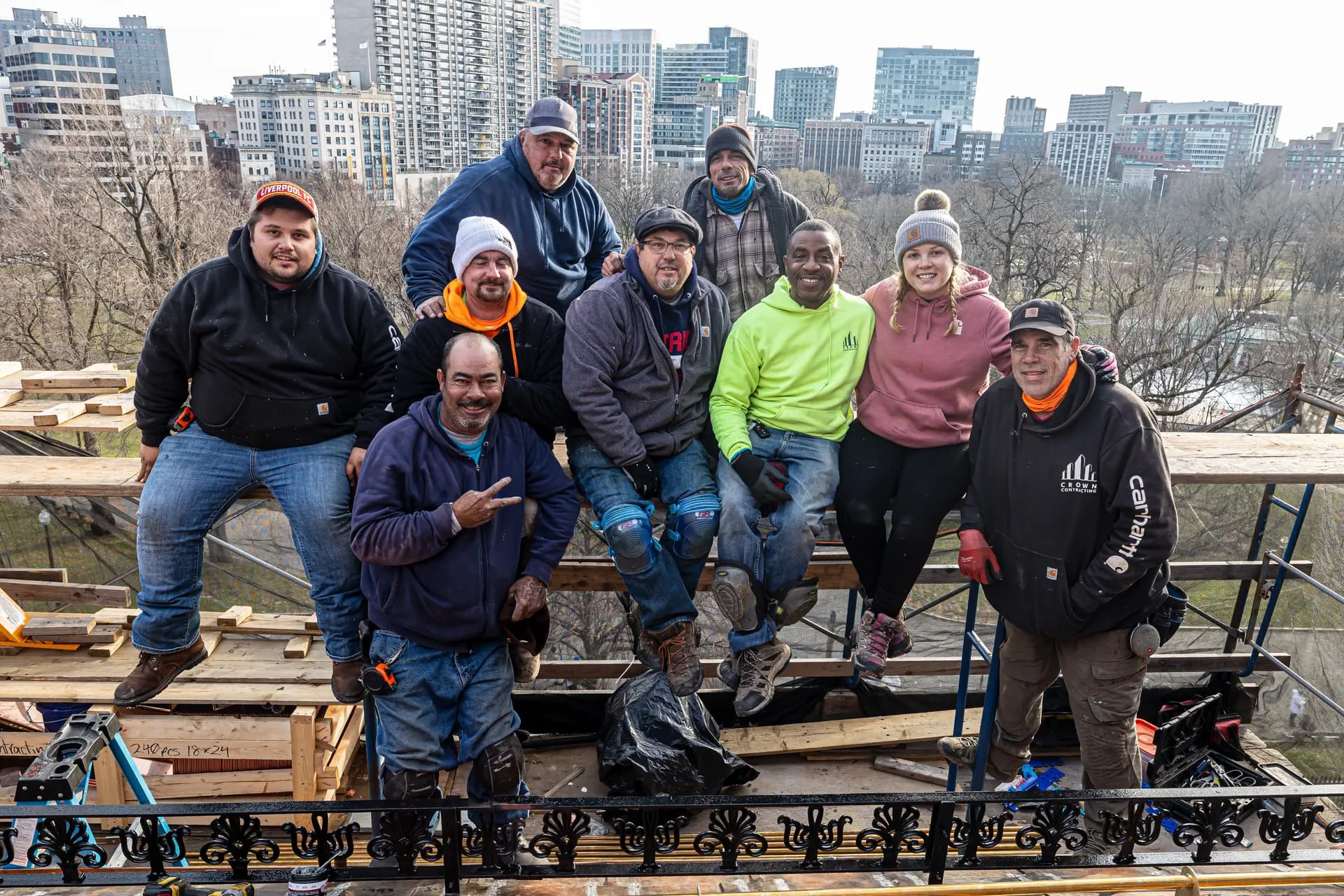 The Crown Contracting crew posed on scaffolding overlooking the Boston skyline.