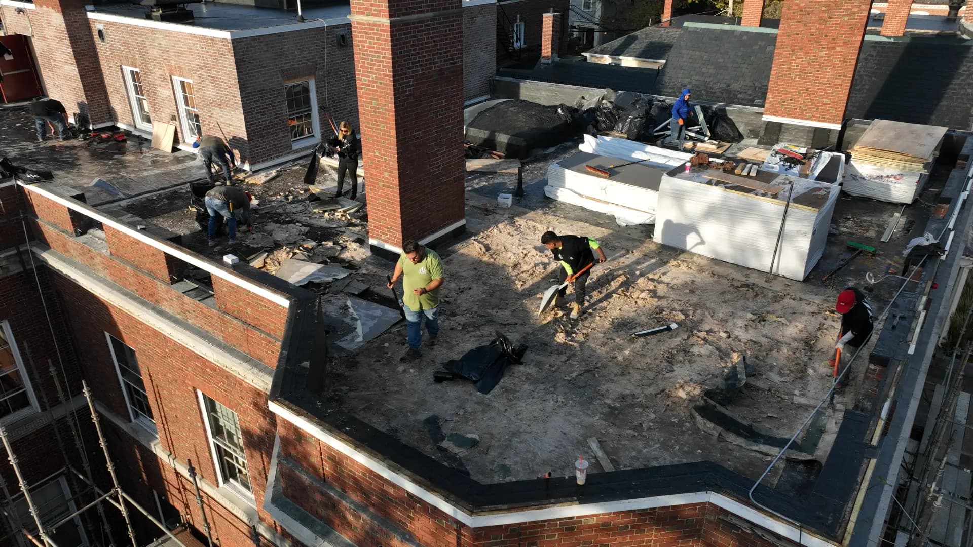 Crown Contracting crew mid tear-off on a commercial roof replacement.