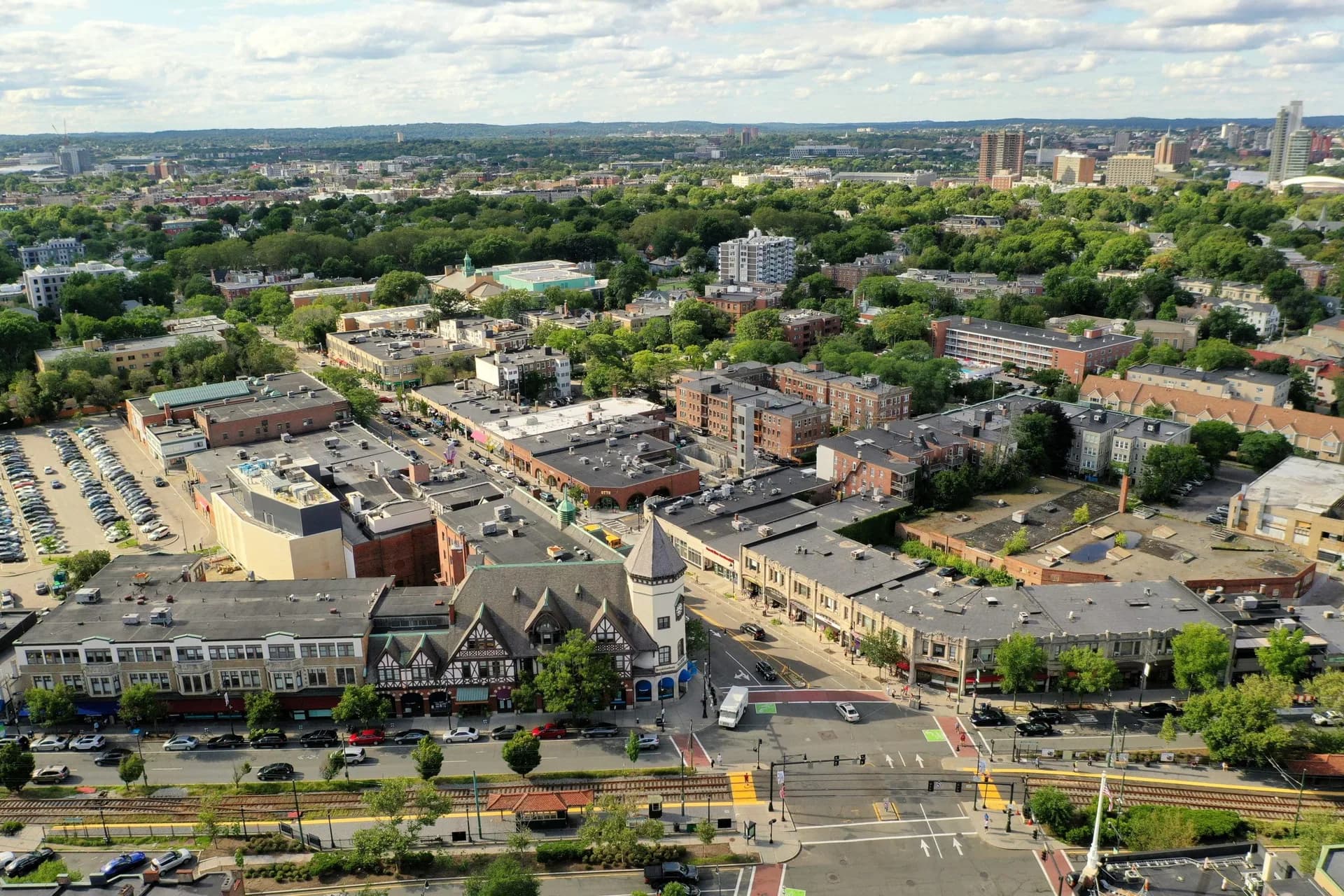 Aerial view over Coolidge Corner in Brookline, with the flat commercial roofs of the Coolidge Plaza block around the Beacon Street intersection.