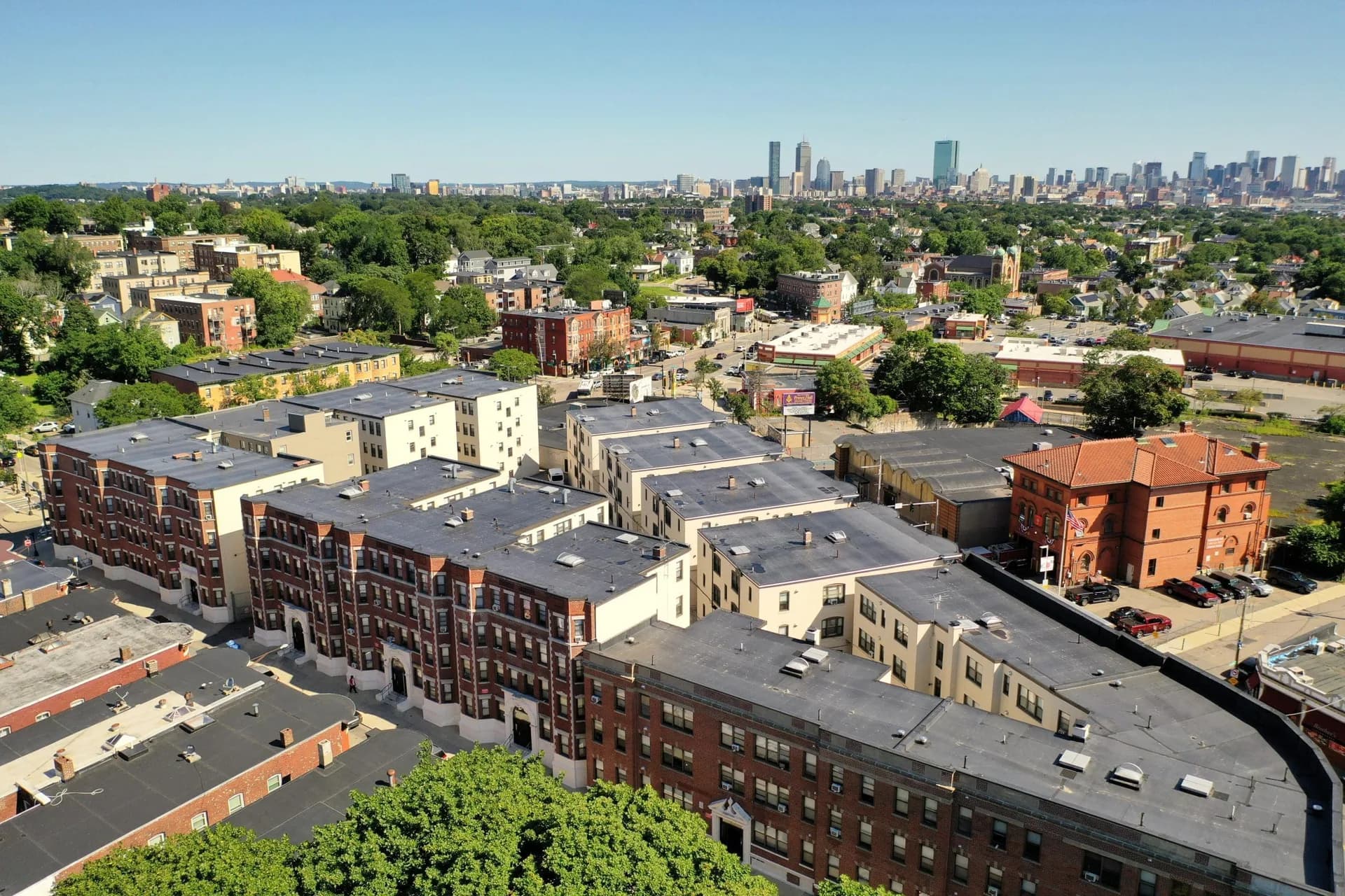 Aerial view of Grove Hall Apartments in Dorchester, a courtyard of brick buildings with flat roofs.