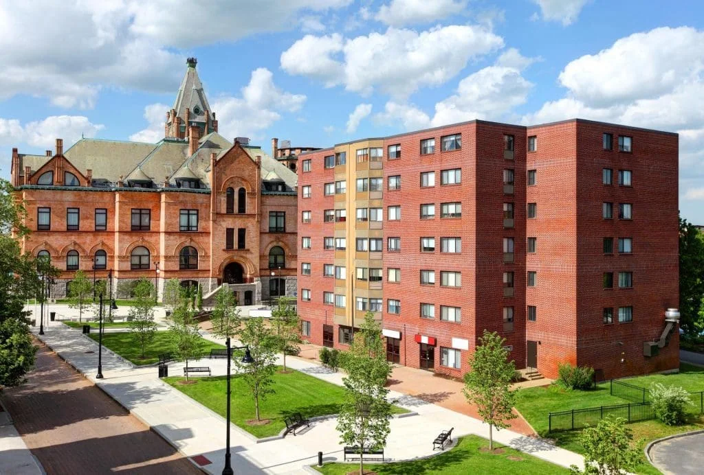 Brockton City Hall beside downtown brick apartment blocks.
