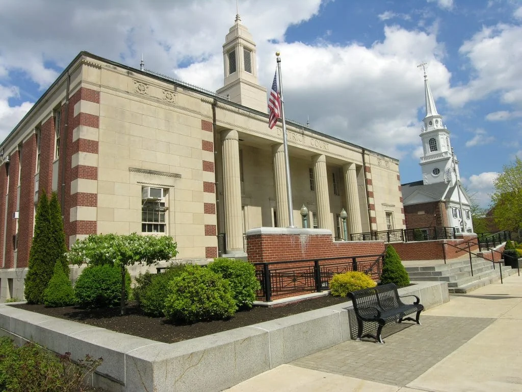 Dedham District Court and a white church steeple in Dedham Square.